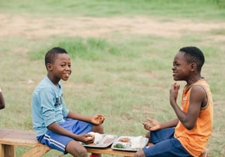 Children eating a nutritious meal prepared by our cooks after football training P Lay It Forward Children eating a nutritious meal prepared by our cooks after football training P Lay It Forward