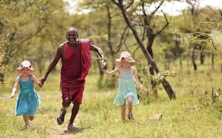 Naboisho Camp Guide And Children Running Naboisho Camp Guide And Children Running