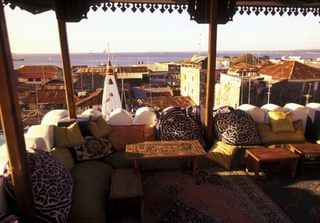 Sunset rooftops seats carved wooden tables Zanzibar Sunset rooftops seats carved wooden tables Zanzibar