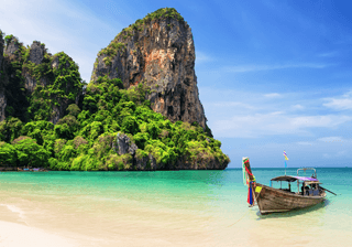 Thai traditional wooden longtail boat and beautiful sand beach Canva Pro Thai traditional wooden longtail boat and beautiful sand beach Canva Pro