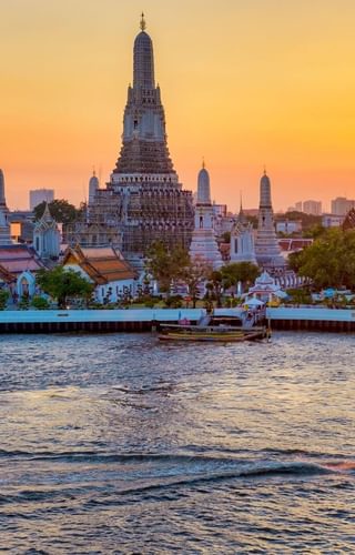 Wat Arun sunrise with riverboat Bangkok Thailand Canva Pro