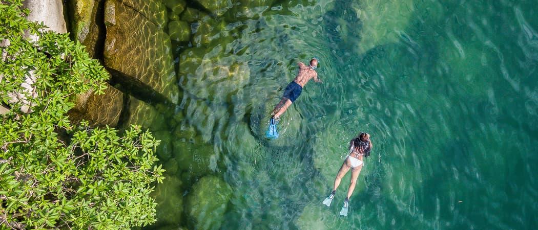 Couple swimming in river Pumulani lodge malawi wetu