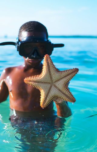 Child with starfish Caye Caulker Belize