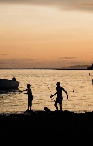 Kids fishing in Mauritius sunset