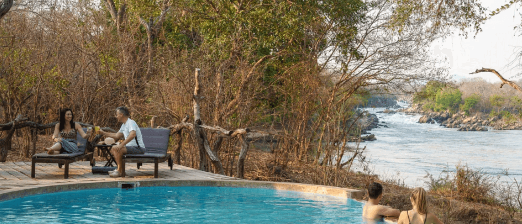 Two couples by pool mkulumadzi lodge malawi website