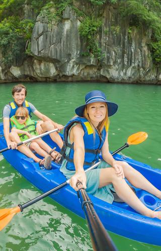 Family canoeing in Ha Long Bay Vietnam
