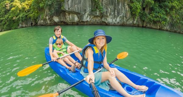 Family canoeing in Ha Long Bay Vietnam